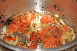 The seeds, onions ginger and tomato being braised