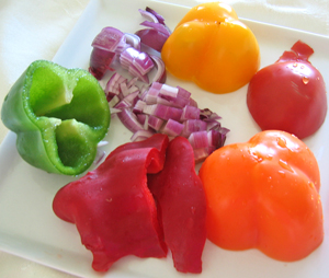 A plate of colorful peppers, but just ½ of a pepper is used in this recipe